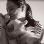 A tender moment captured between a woman and her cat in Heredia, Costa Rica.